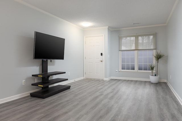 unfurnished living room with ornamental molding, a textured ceiling, and light wood-type flooring