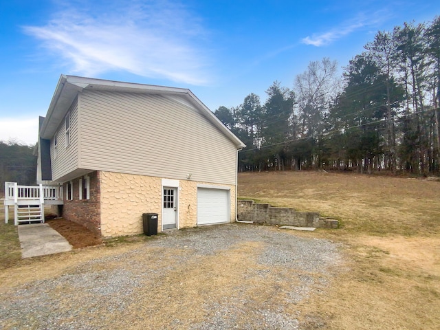 view of property exterior featuring a wooden deck and a garage