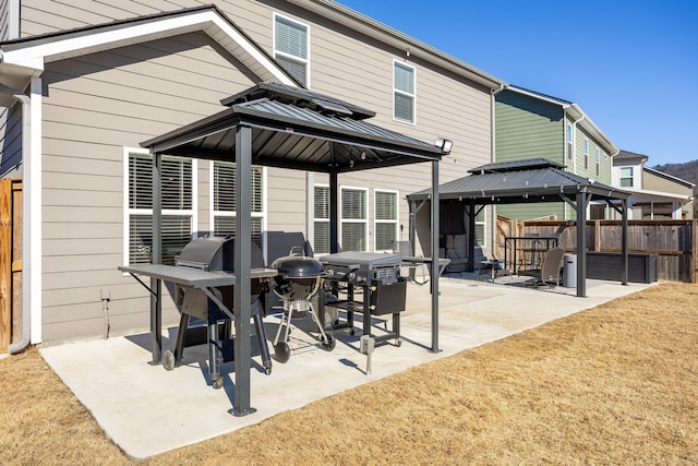 rear view of house featuring a patio and a gazebo