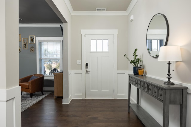 foyer entrance with dark hardwood / wood-style floors and crown molding