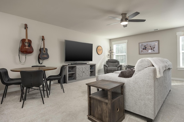 carpeted living room featuring ceiling fan