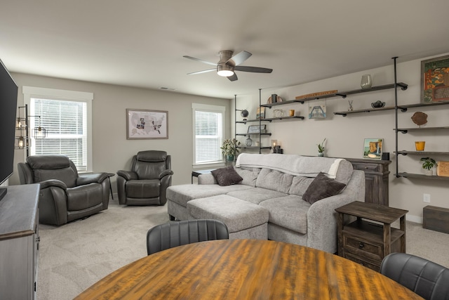 carpeted living room featuring ceiling fan