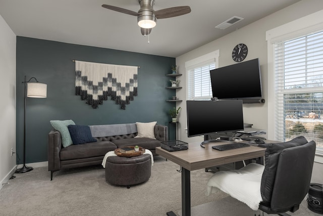 office featuring a healthy amount of sunlight, light colored carpet, and ceiling fan