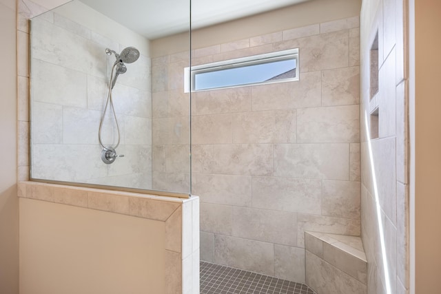 bathroom with tiled shower