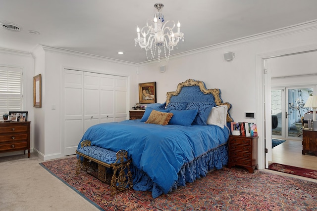 carpeted bedroom with crown molding, a chandelier, and a closet