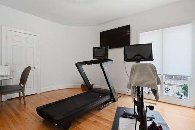 exercise room with hardwood / wood-style flooring