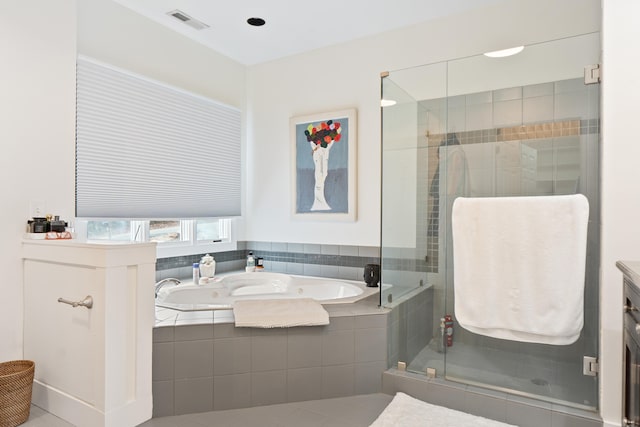 bathroom with vanity and separate shower and tub