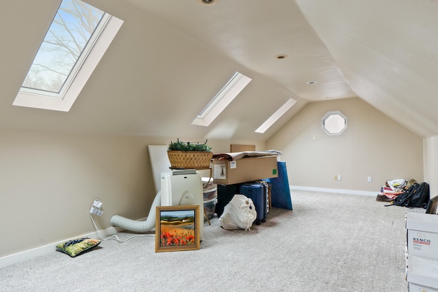 additional living space featuring carpet floors and lofted ceiling with skylight