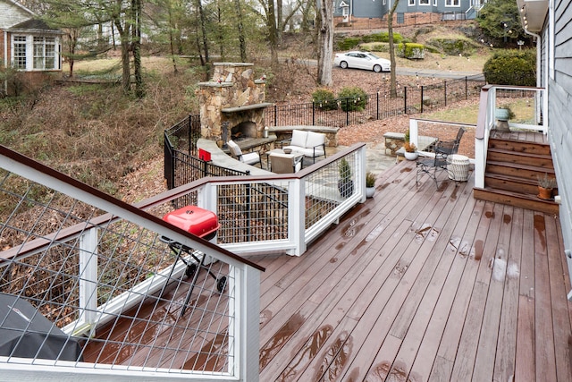 wooden deck with an outdoor living space with a fireplace