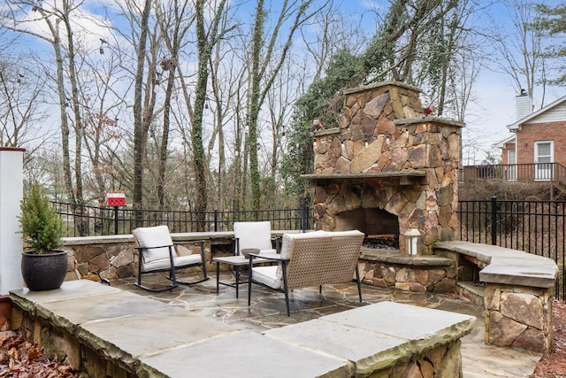 view of patio with an outdoor stone fireplace