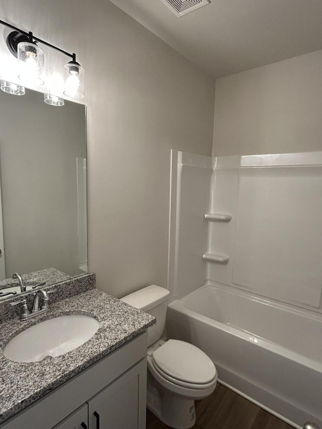 7553 Snow Cone Way Unit 17, Ooltewah, TN 37363 - bathroom featuring toilet, vanity, wood finished floors, and washtub / shower combination