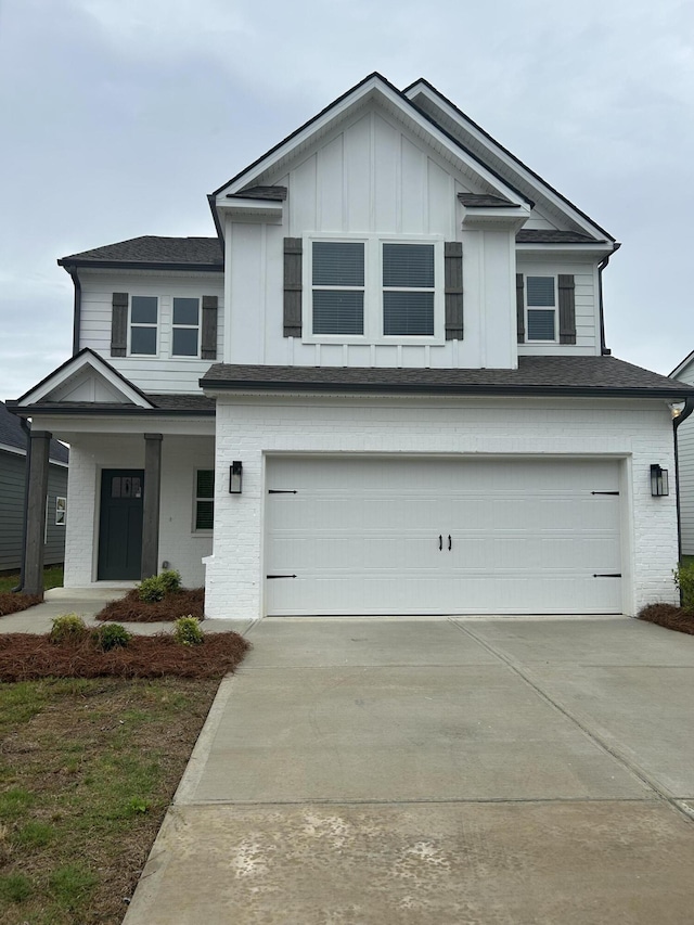 7553 Snow Cone Way Unit 17, Ooltewah, TN 37363 - view of front of property with a garage, driveway, board and batten siding, a porch, and brick siding