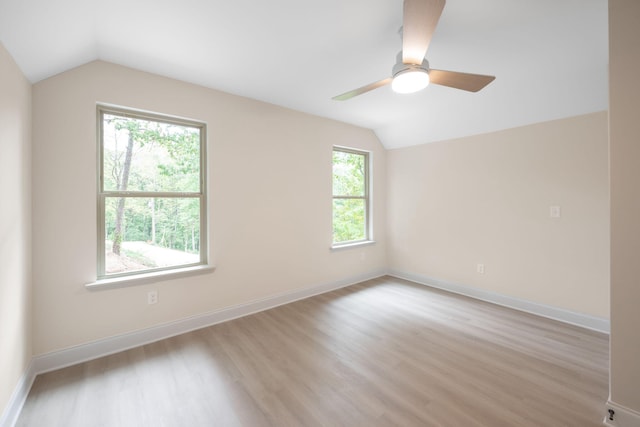 unfurnished room with ceiling fan, light hardwood / wood-style flooring, and lofted ceiling