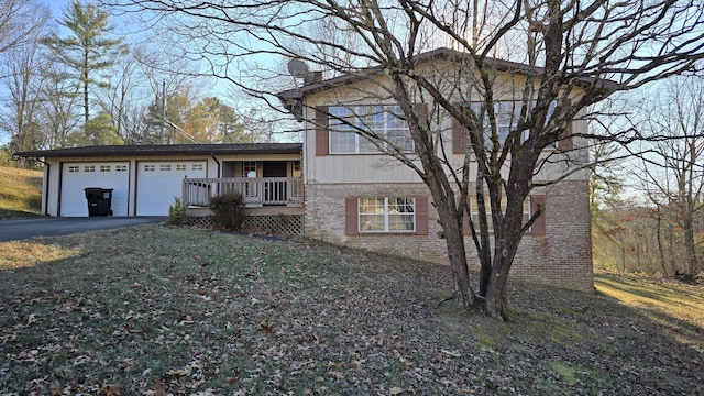 split level home featuring a garage and a front lawn