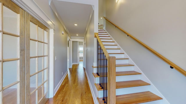 stairs featuring hardwood / wood-style floors