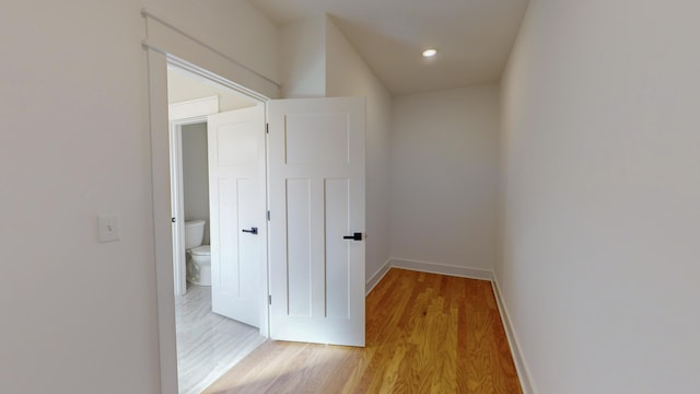 hallway with light hardwood / wood-style floors