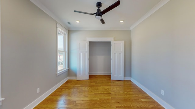 unfurnished bedroom with ceiling fan, ornamental molding, a closet, and light hardwood / wood-style flooring