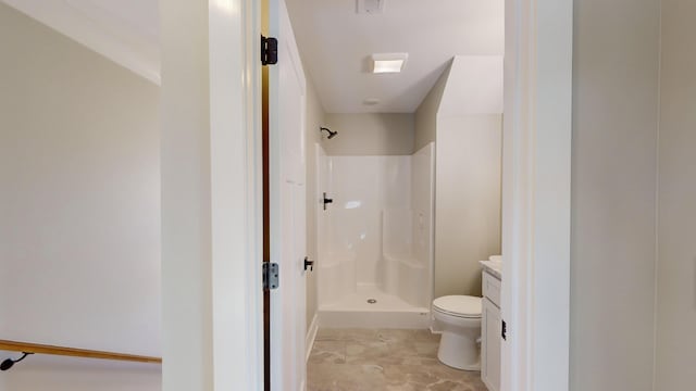 bathroom featuring vanity, toilet, and a shower