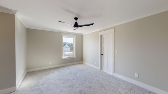 carpeted empty room with crown molding and ceiling fan