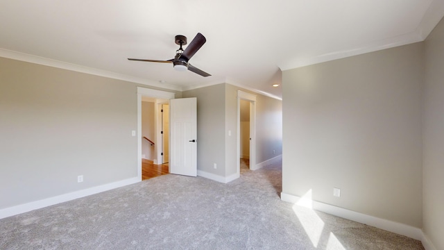 unfurnished bedroom with ceiling fan, ornamental molding, and light carpet