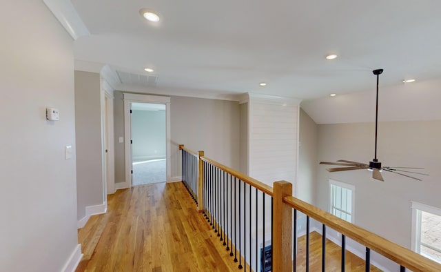 hallway with lofted ceiling and light hardwood / wood-style floors