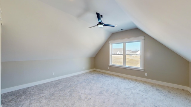 additional living space featuring vaulted ceiling, light colored carpet, and ceiling fan