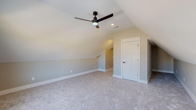 additional living space featuring ceiling fan, light colored carpet, and lofted ceiling