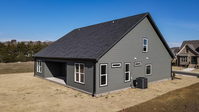 rear view of property with central AC