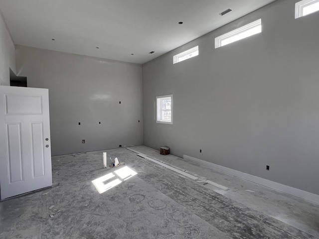 unfurnished room with a high ceiling