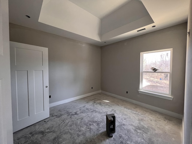 unfurnished room with a tray ceiling