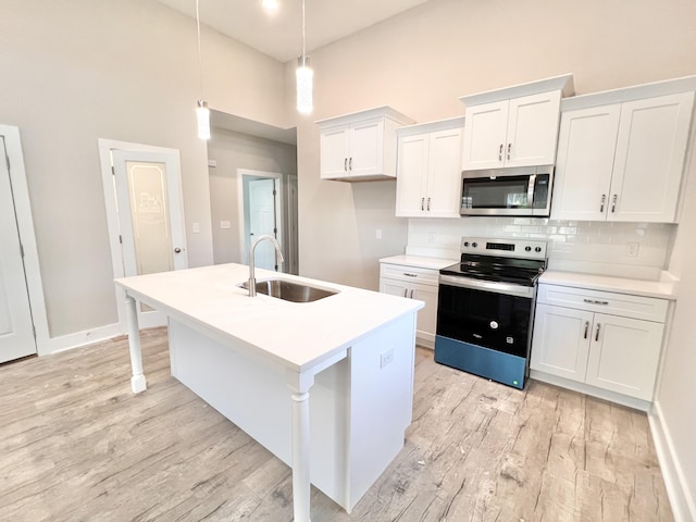 159 Rock Bridge Dr, Ringgold, GA 30736 - kitchen with appliances with stainless steel finishes, a sink, light wood-style floors, tasteful backsplash, and a towering ceiling