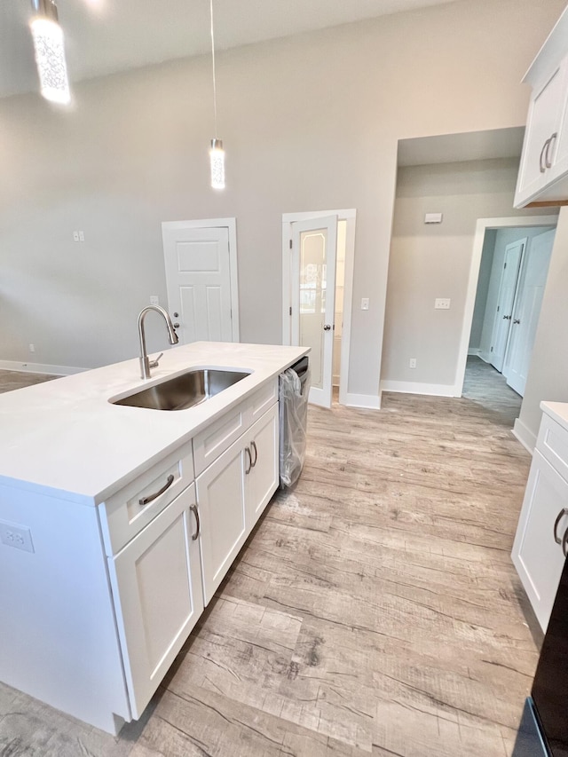 159 Rock Bridge Dr, Ringgold, GA 30736 - kitchen with light wood-type flooring, a sink, dishwasher, and light countertops