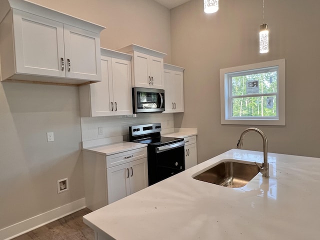 159 Rock Bridge Dr, Ringgold, GA 30736 - kitchen with stainless steel appliances, a sink, tasteful backsplash, white cabinets, and light countertops
