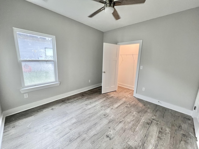 159 Rock Bridge Dr, Ringgold, GA 30736 - unfurnished bedroom featuring wood finished floors, a spacious closet, and baseboards