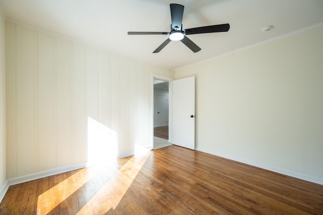 spare room featuring ornamental molding and wood-type flooring