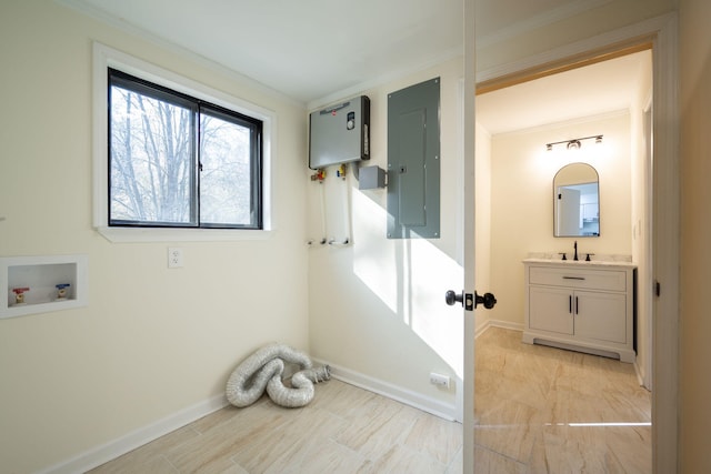 clothes washing area with hookup for a washing machine, crown molding, electric panel, and sink