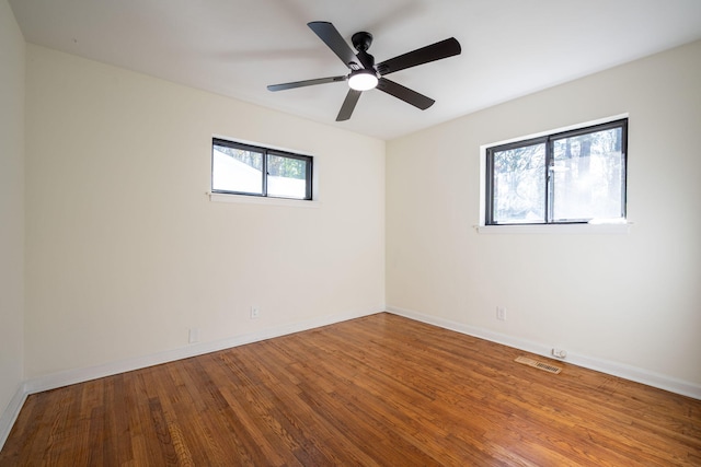 empty room with wood-type flooring and ceiling fan