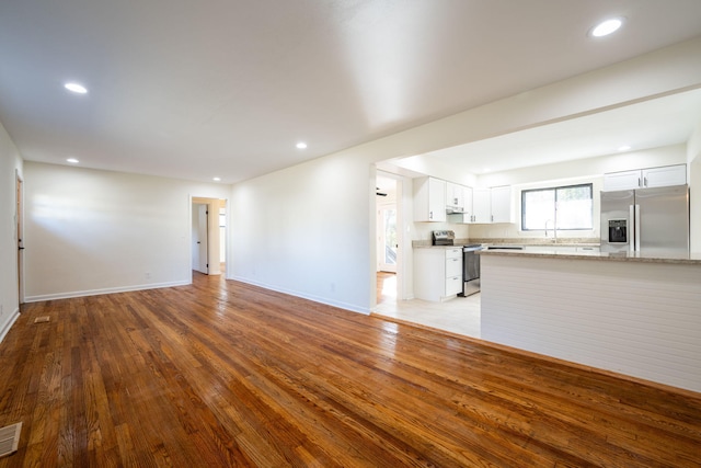 unfurnished living room featuring light wood-type flooring