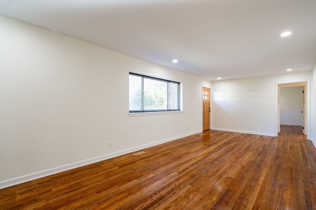 spare room with hardwood / wood-style flooring