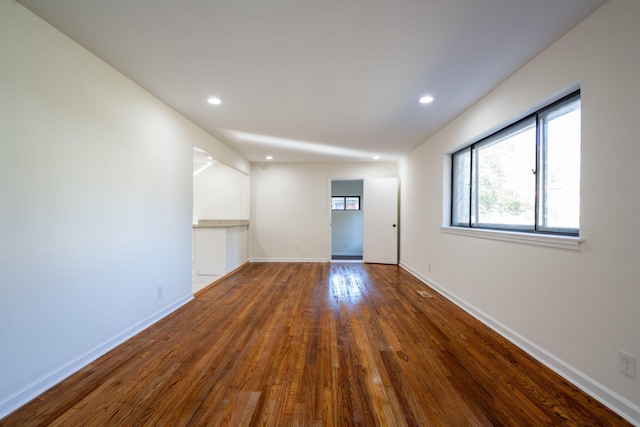 unfurnished room with wood-type flooring