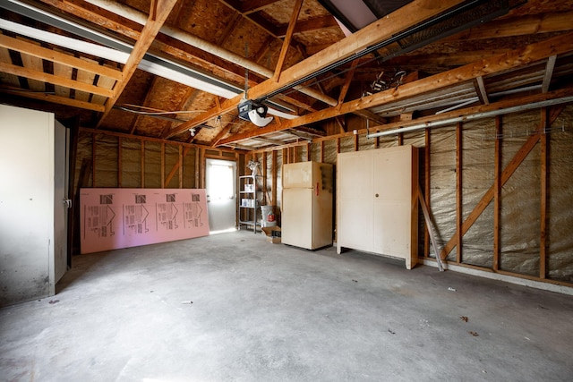 garage featuring a garage door opener and white fridge