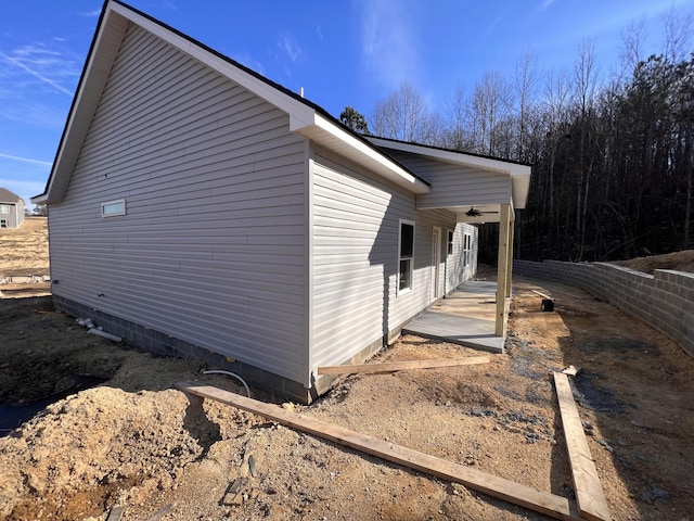 view of side of property with a patio and ceiling fan