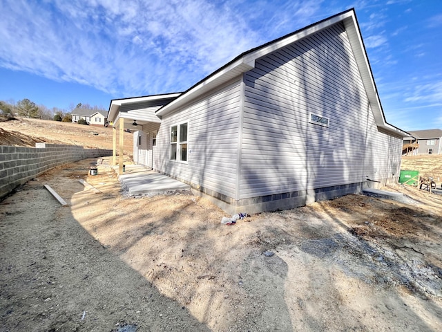 view of side of property featuring a patio