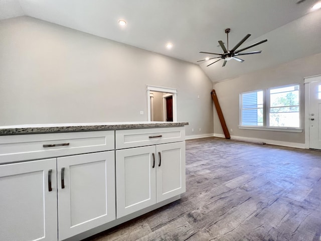interior space featuring recessed lighting, lofted ceiling, a ceiling fan, baseboards, and wood finished floors