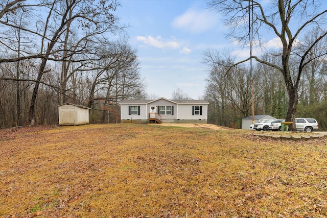 single story home with a storage unit and a front yard