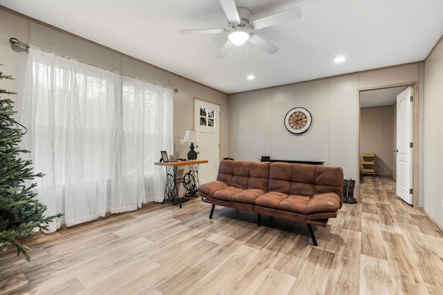 living room featuring ceiling fan and light hardwood / wood-style flooring