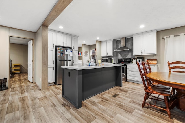 kitchen with white cabinetry, stainless steel appliances, an island with sink, and wall chimney exhaust hood