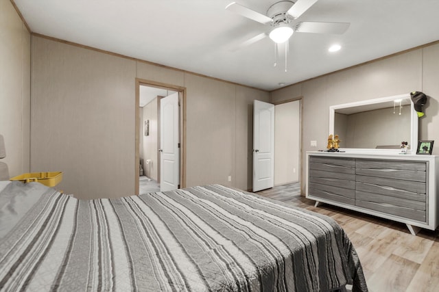 bedroom with ceiling fan, hardwood / wood-style floors, and ensuite bath