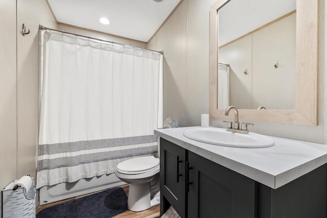 full bathroom with vanity, shower / tub combo, and toilet