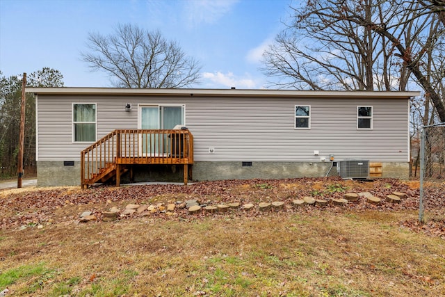 back of house with a yard and central air condition unit